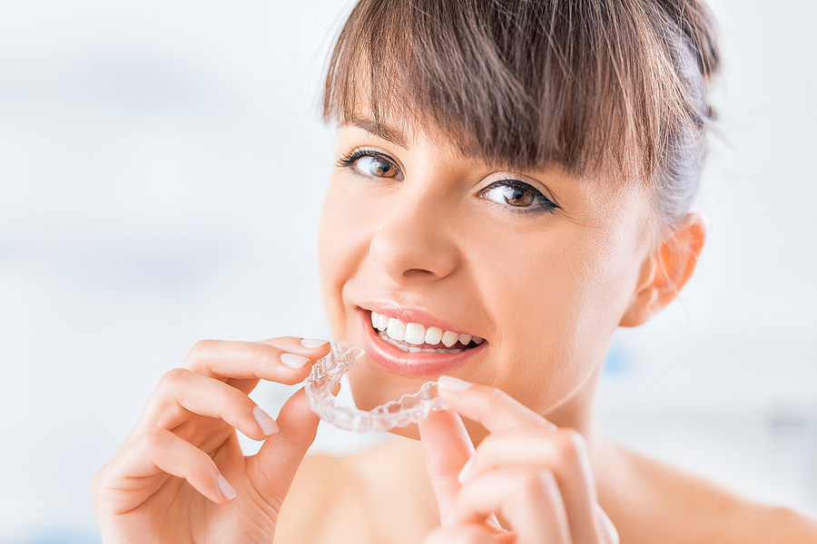 Woman putting in whitening tray