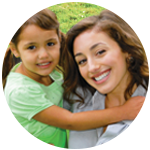 Mother holding her daughter and smiling.