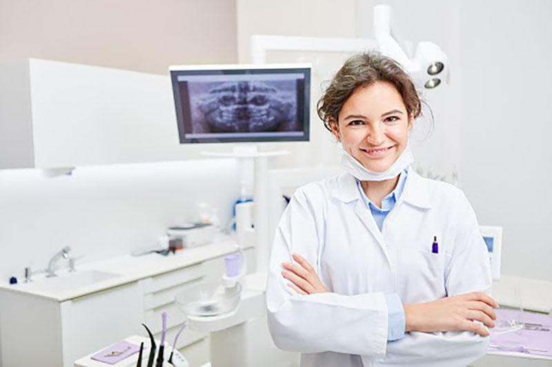 Smiling assistant after sterilizing equipment